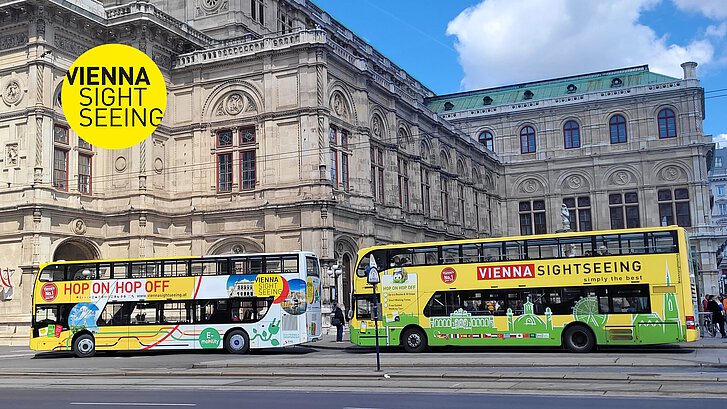 Zwei Vienna Sightseeing Hop On Hop Off Busse halten vor der Wiener Oper